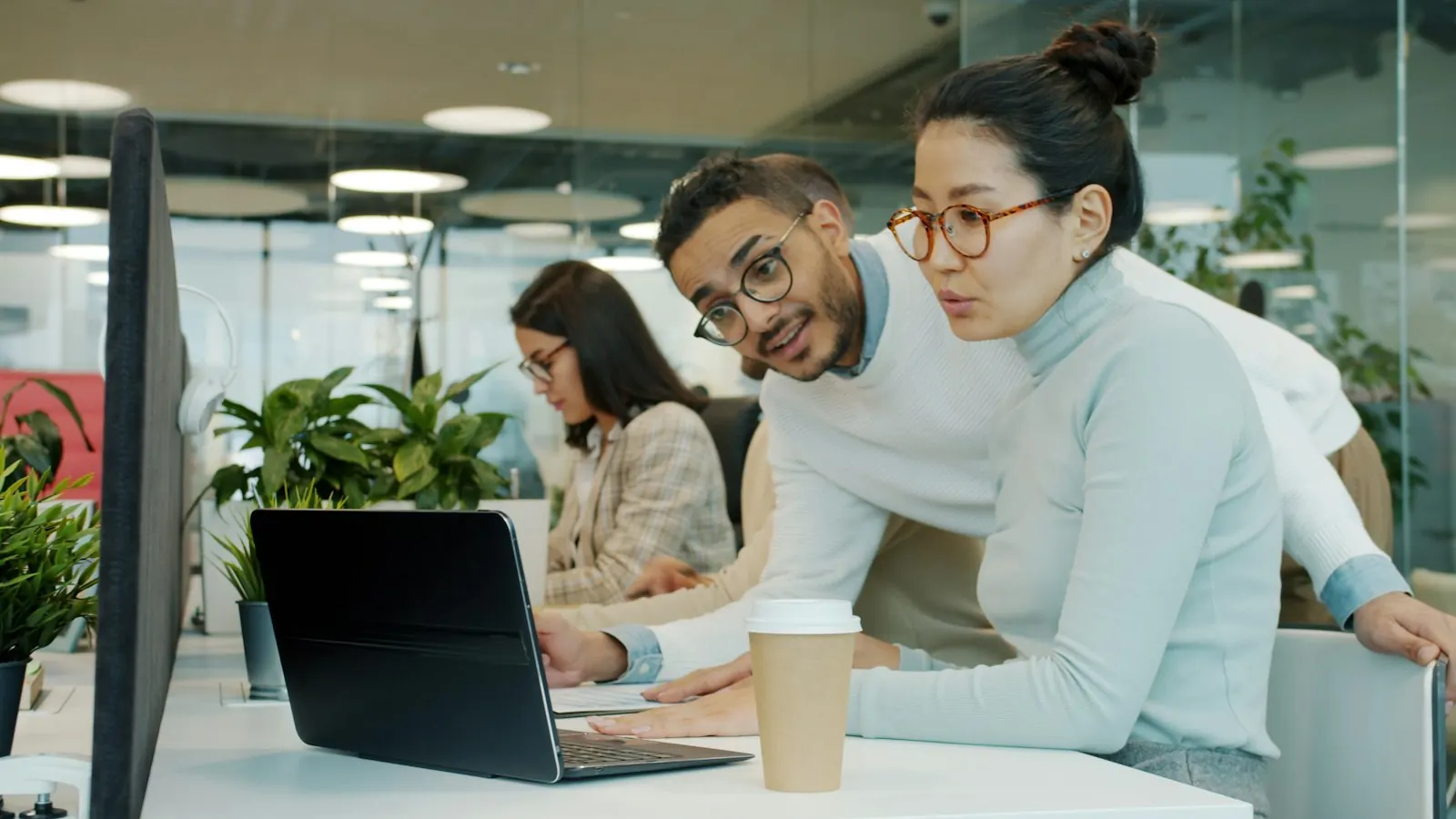 Two colleagues working together on a laptop